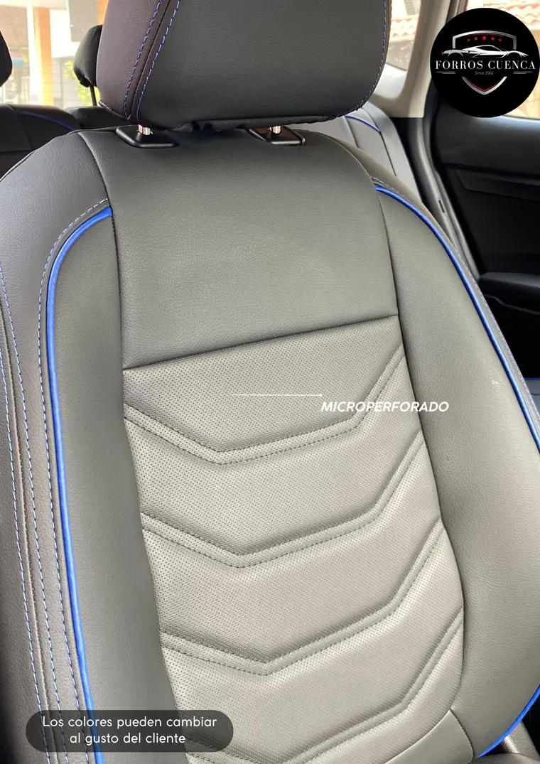 Detalle de respaldo en cuero negro con panel microperforado gris y ribete azul